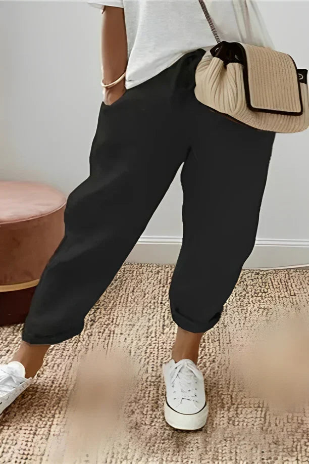 Plain-colored trousers with drawstring and slanted pocket